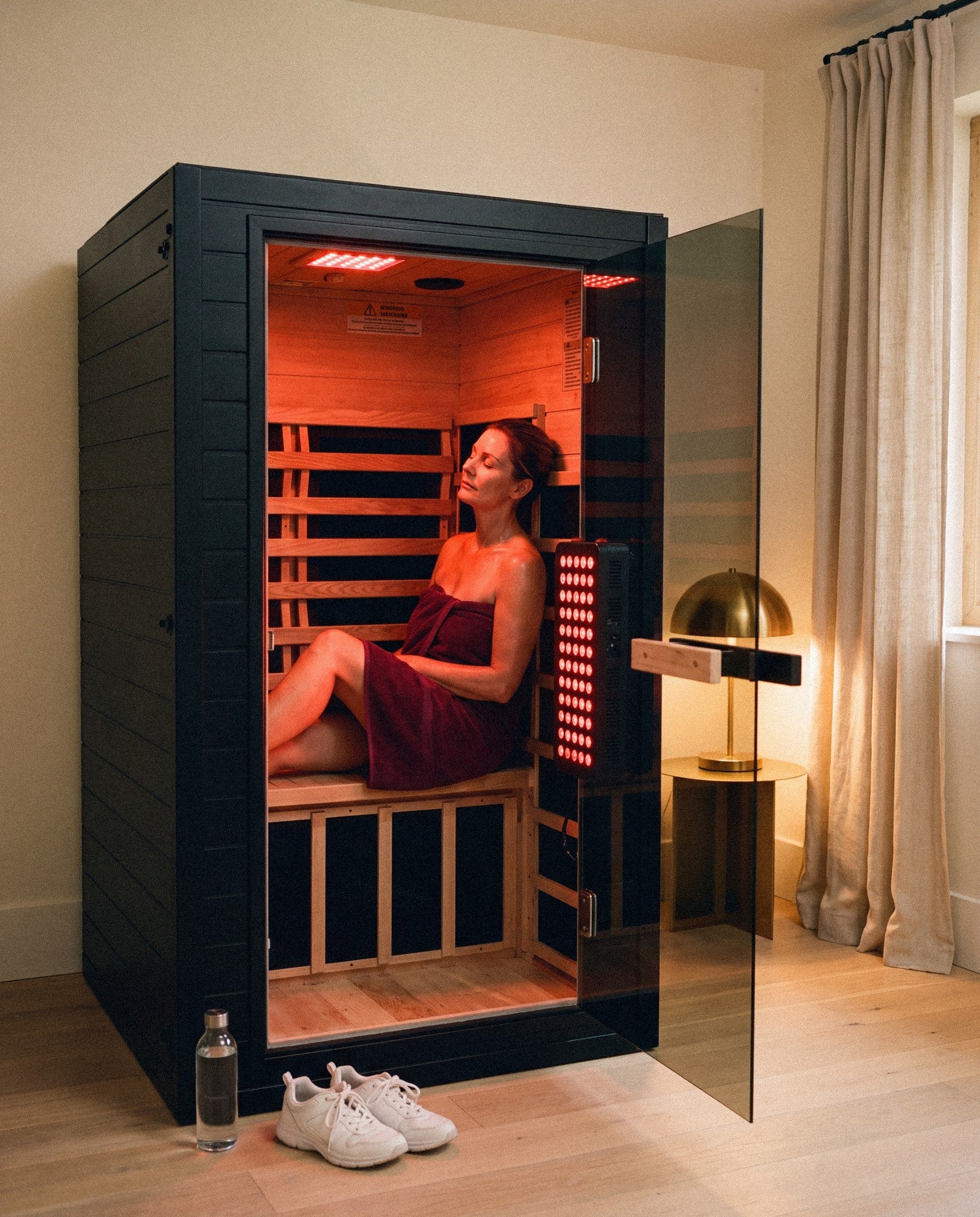 SaunaBox Solara in a room in the evening