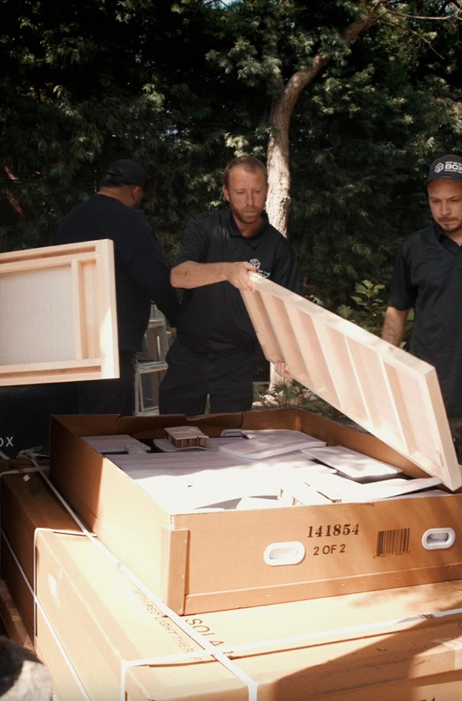 SaunaBox install team unpacking sauna panels