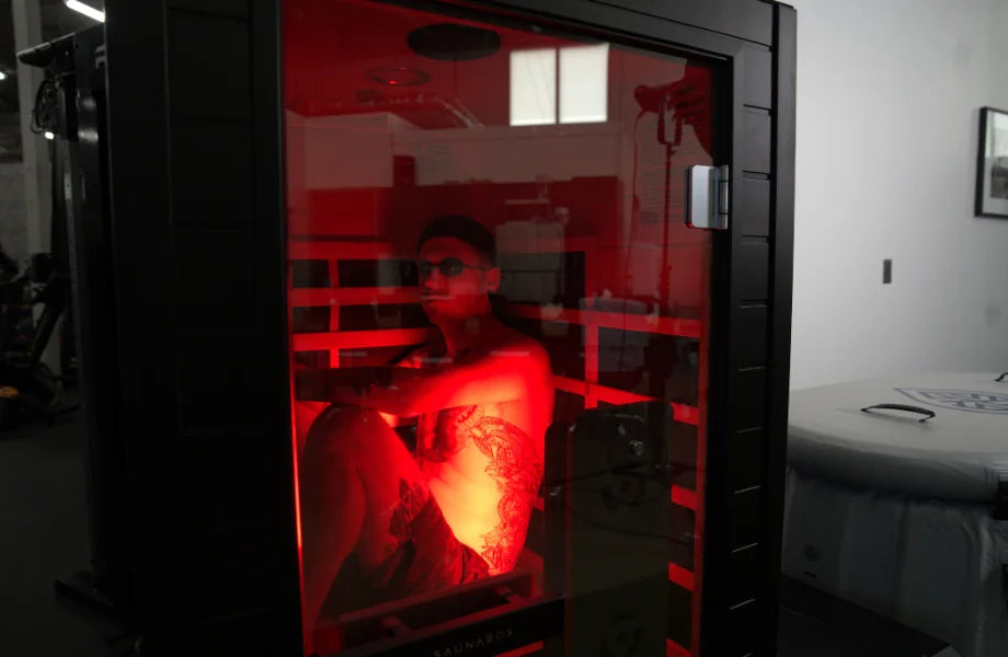Fitness expert sitting inside the SaunaBox Solara infrared sauna during review testing